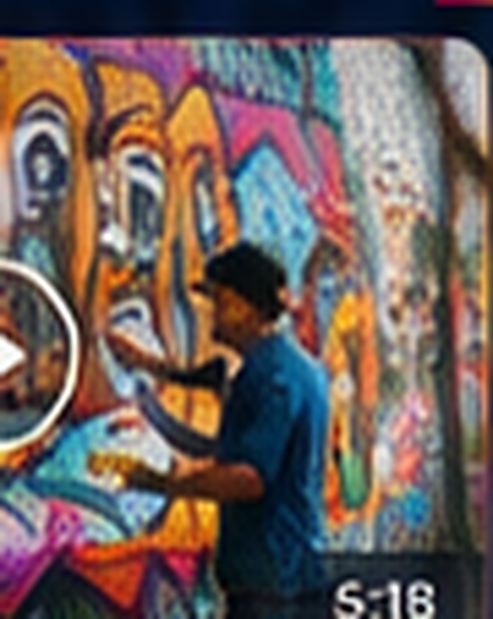 A muralist painting a colorful community wall for The Artist Behind the Wall story